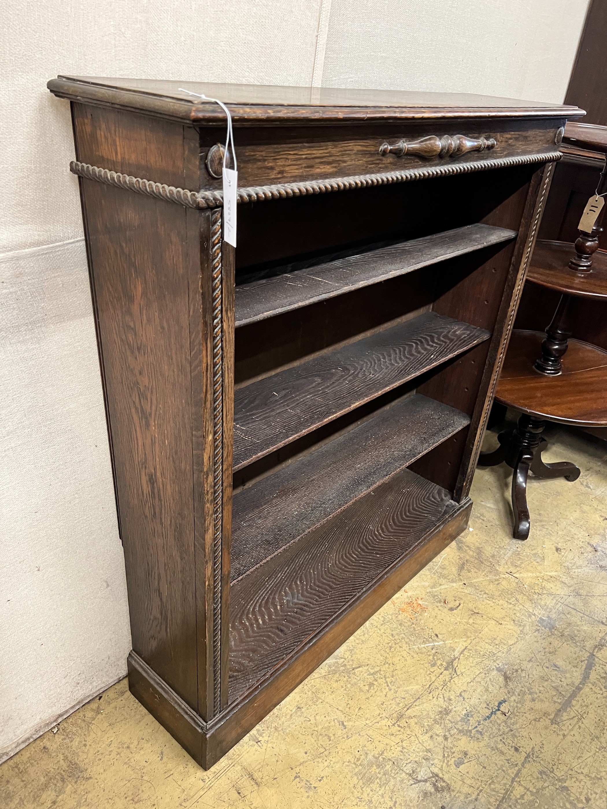 A 1920's oak open bookcase, length 99cm, depth 25cm, height 108cm